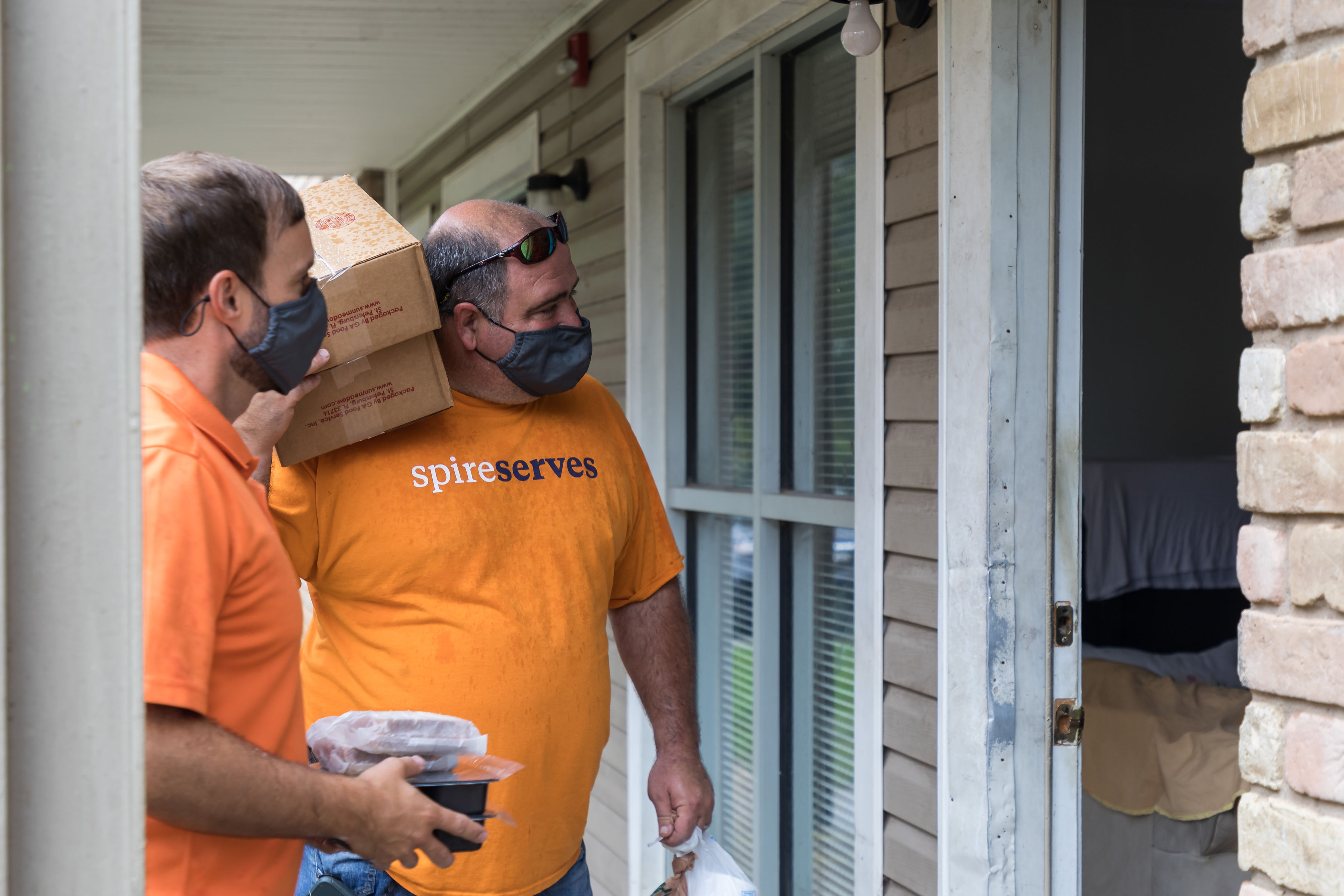 Image of: Spire volunteers with Meals on Wheels delivering food