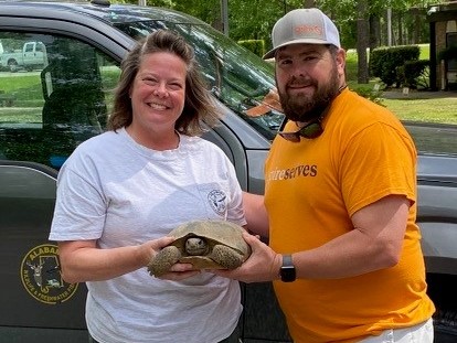 Image of Spire employee holding a tortoise