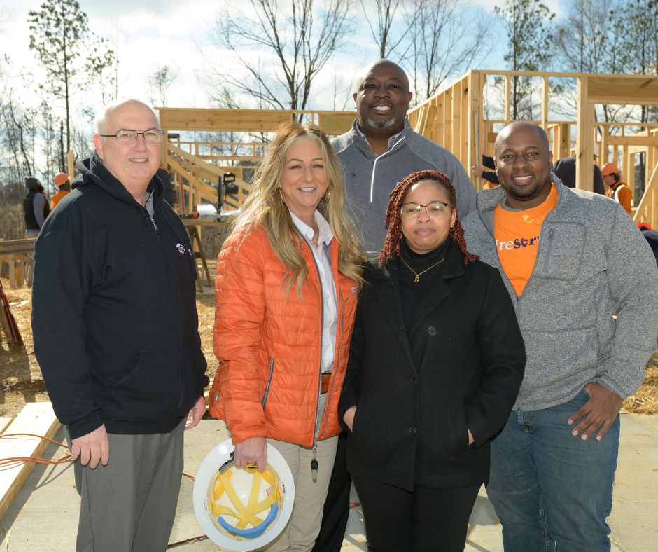Joe Hampton and others pictured with new Habitat home owners