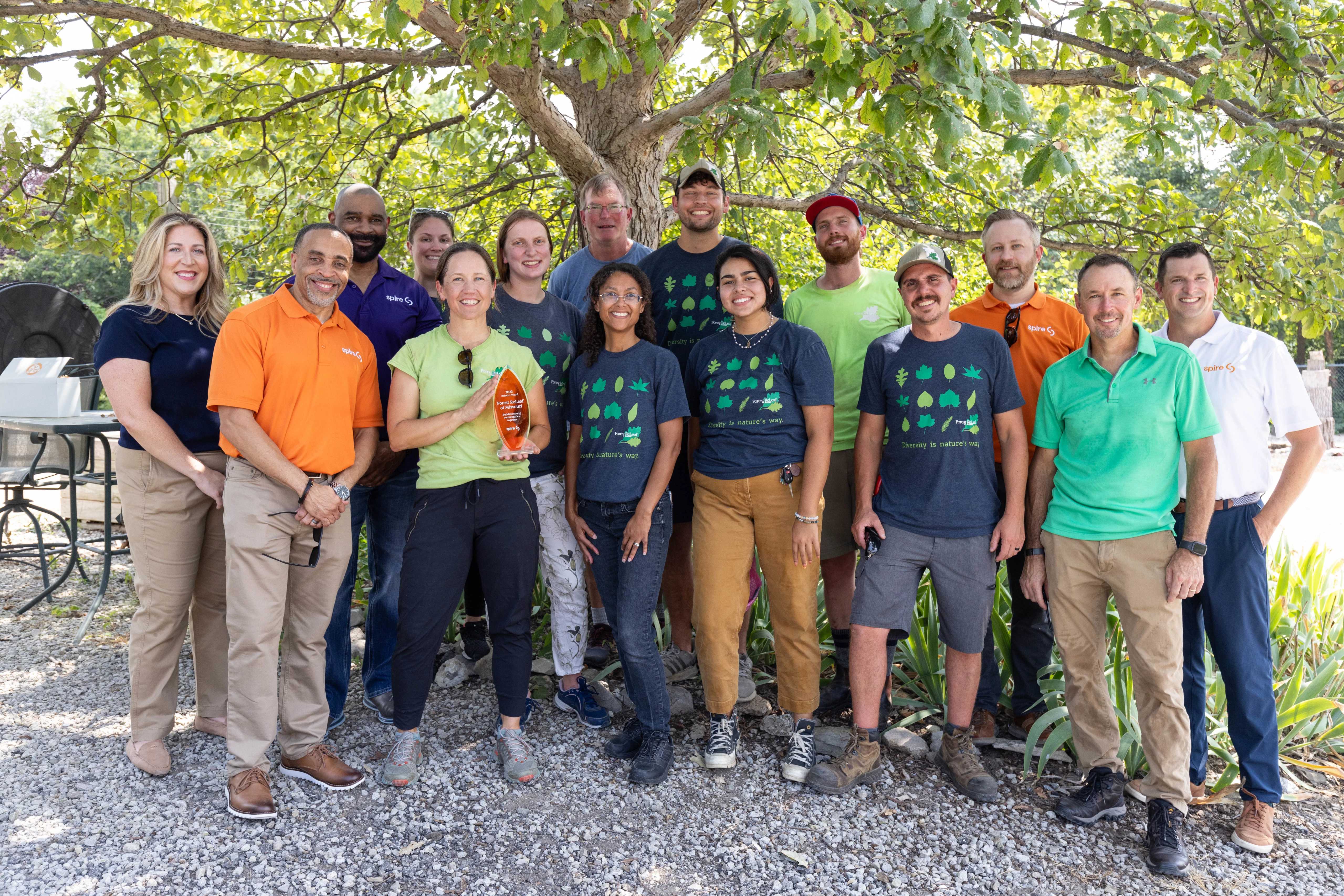 Image of Spire employees and Forest ReLeaf volunteers in front of a tree