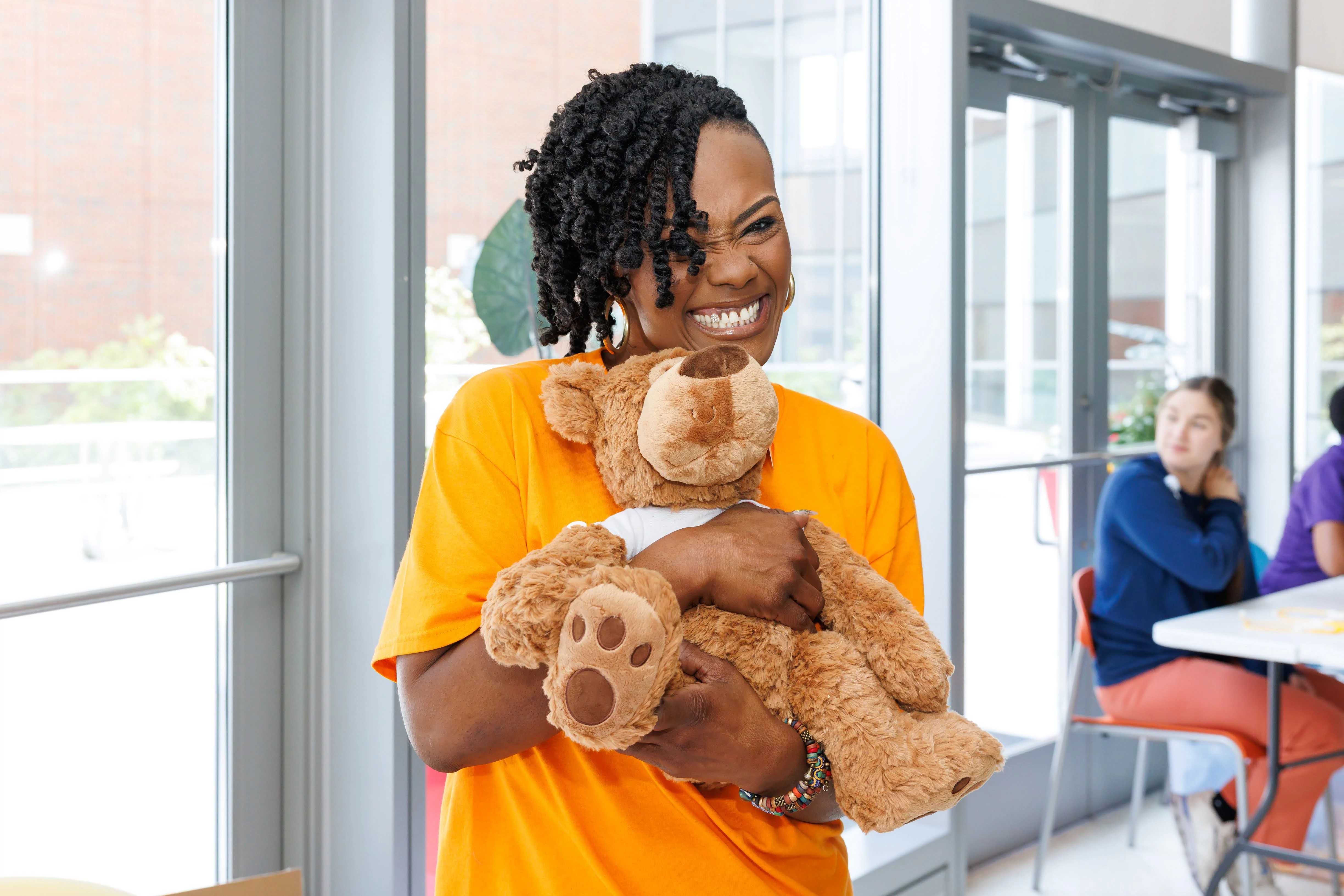 Image of Spire employee holding a teddy bear at Children's of Alabama