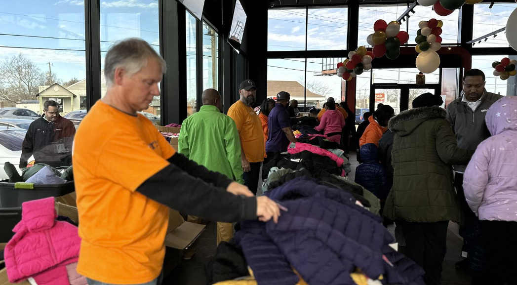 Spire volunteer organizing coats