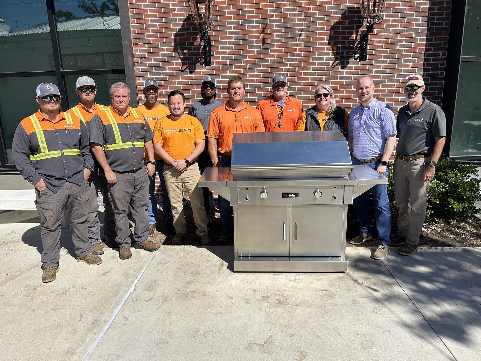 Image of Spire volunteers by natural gas grill