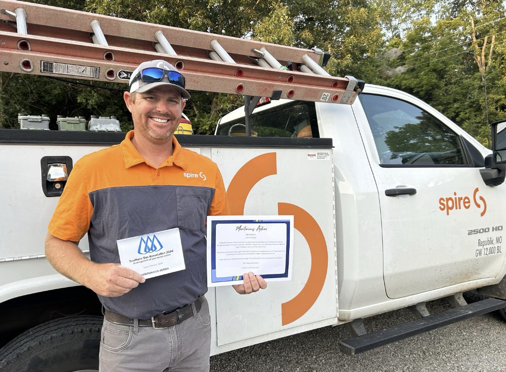 Image of Spire employee in front of his work truck