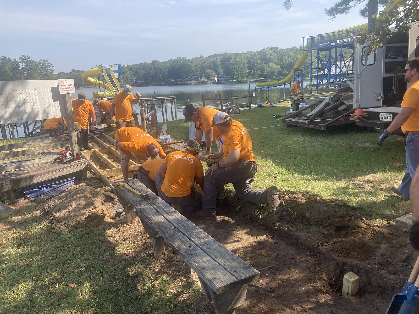 spire employees building deck on campground