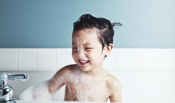 Child playing in bubble bath
