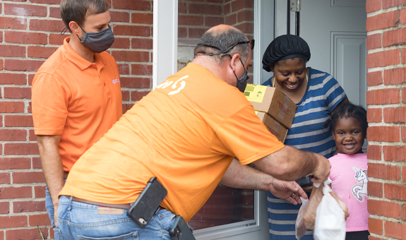 Spire employees donating goods to family