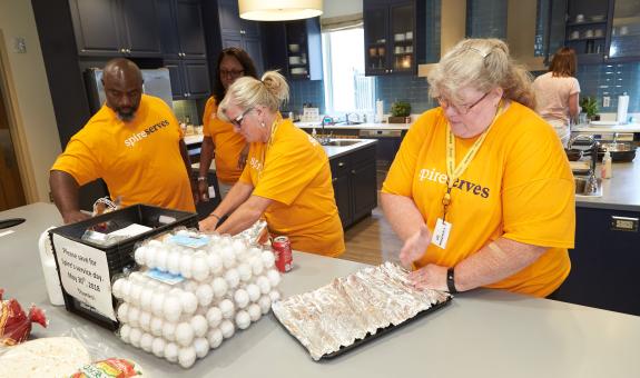 Image of: Spire volunteers preparing meals for Ronald McDonald House