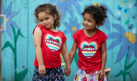 Image of little girls smiling at each other