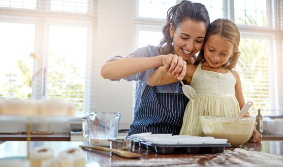 Image of mother and daughter baking cupcakes