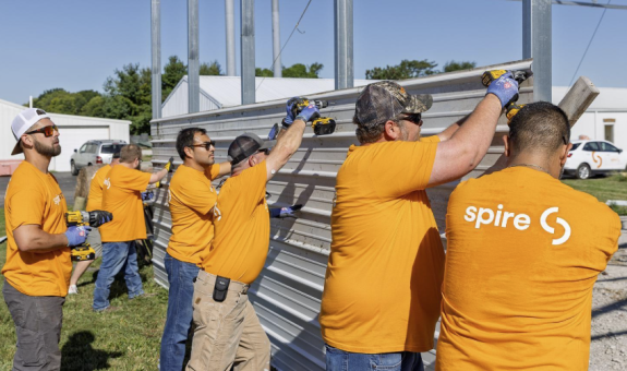 Volunteers putting up wall of barn