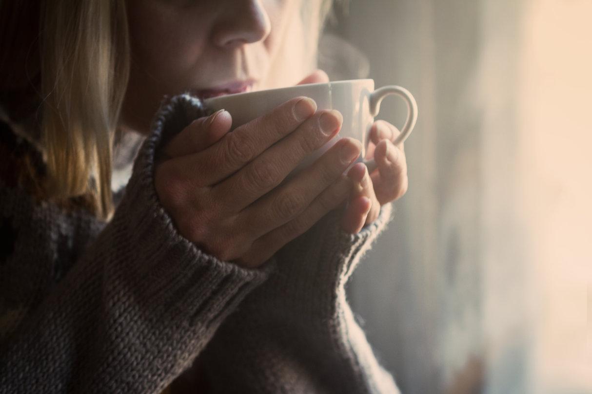 Woman holding cup of coffee
