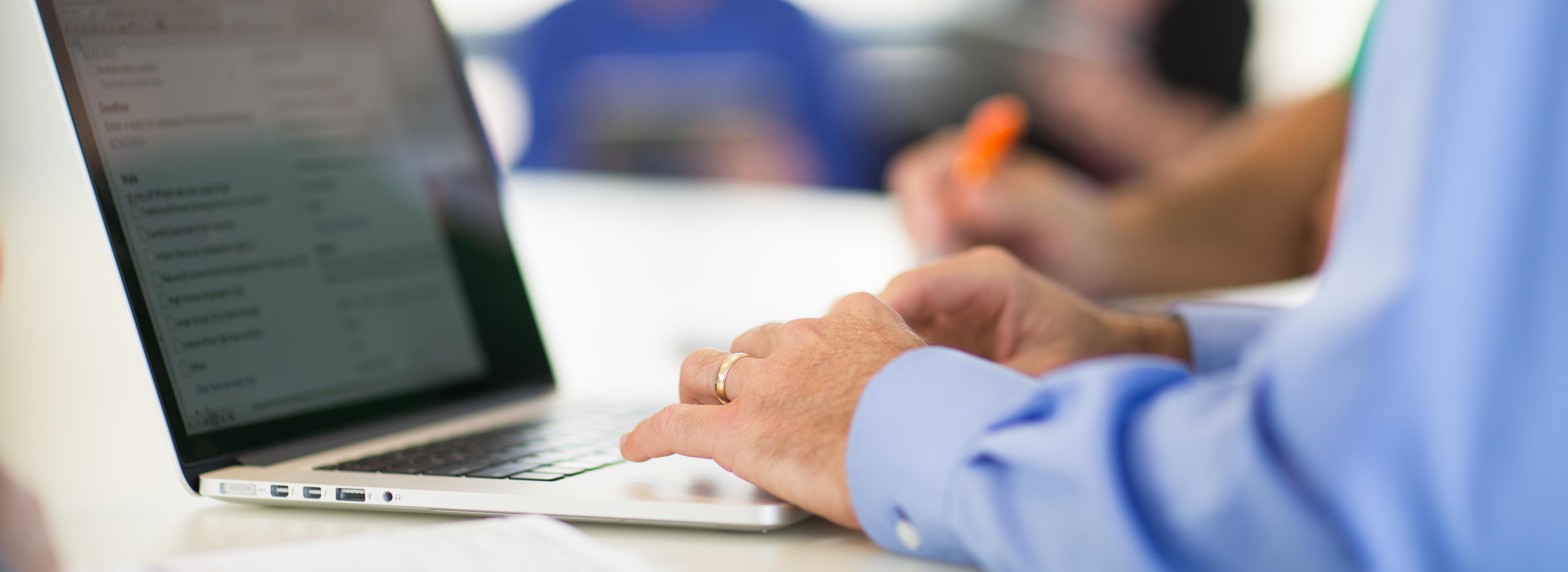 Image of: Man typing on computer