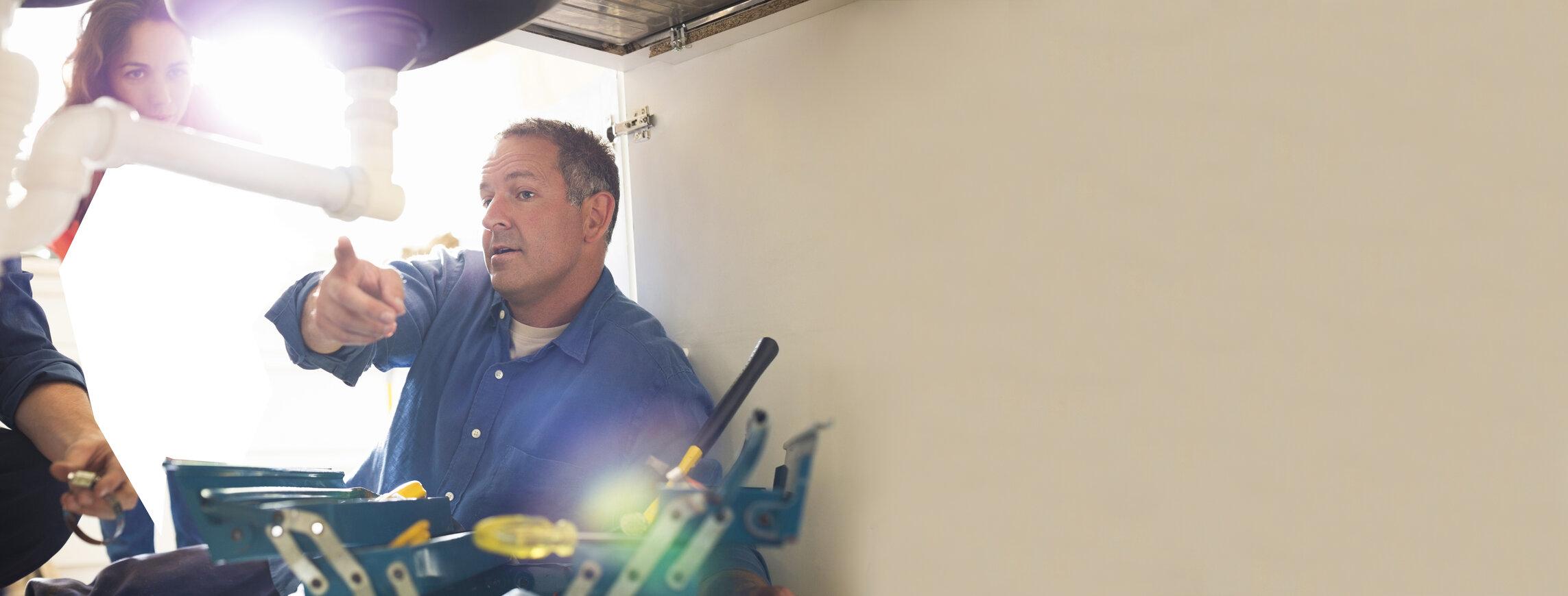 Image of: Contractor pointing to equipment