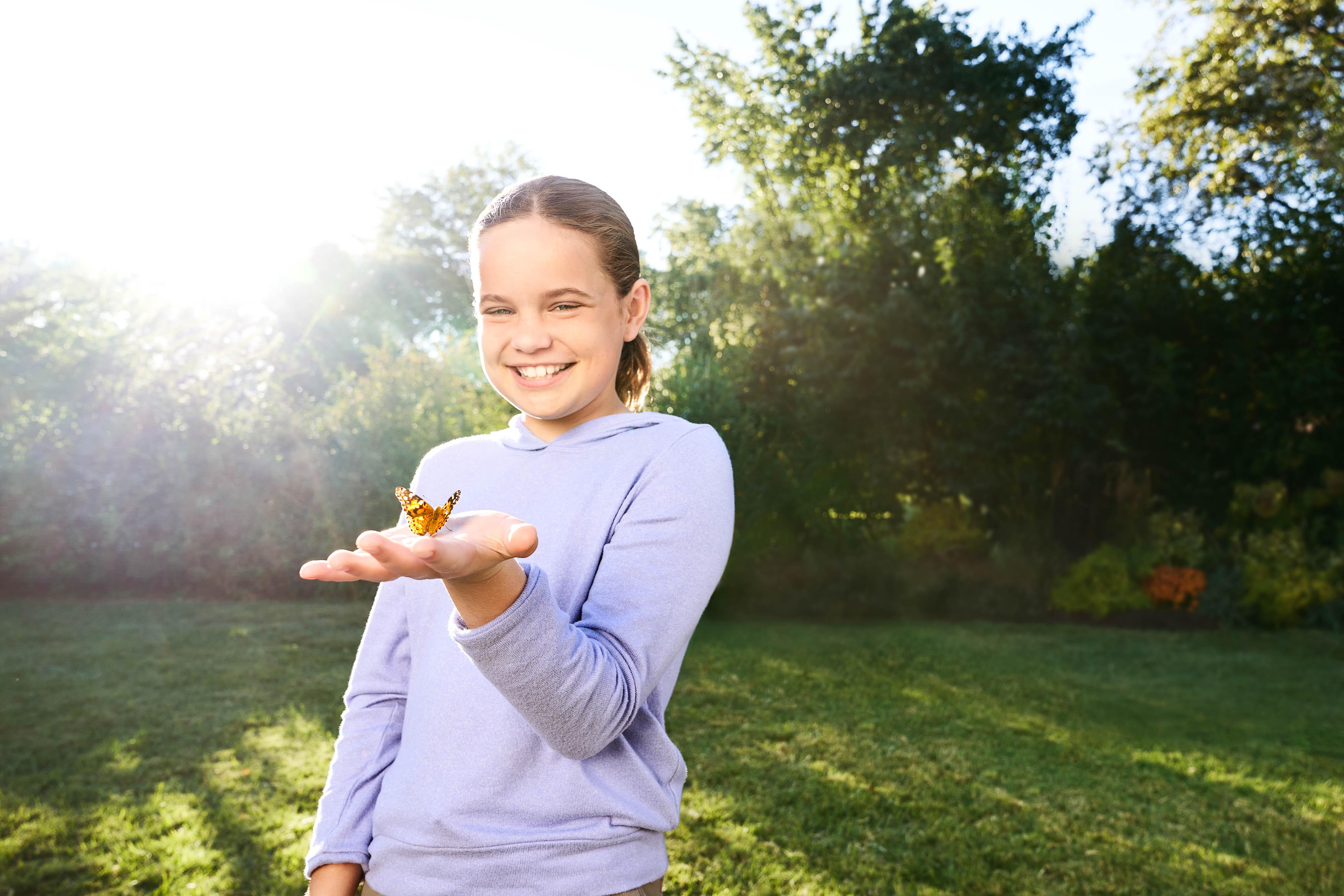 Image of: Little girl holding butterfly