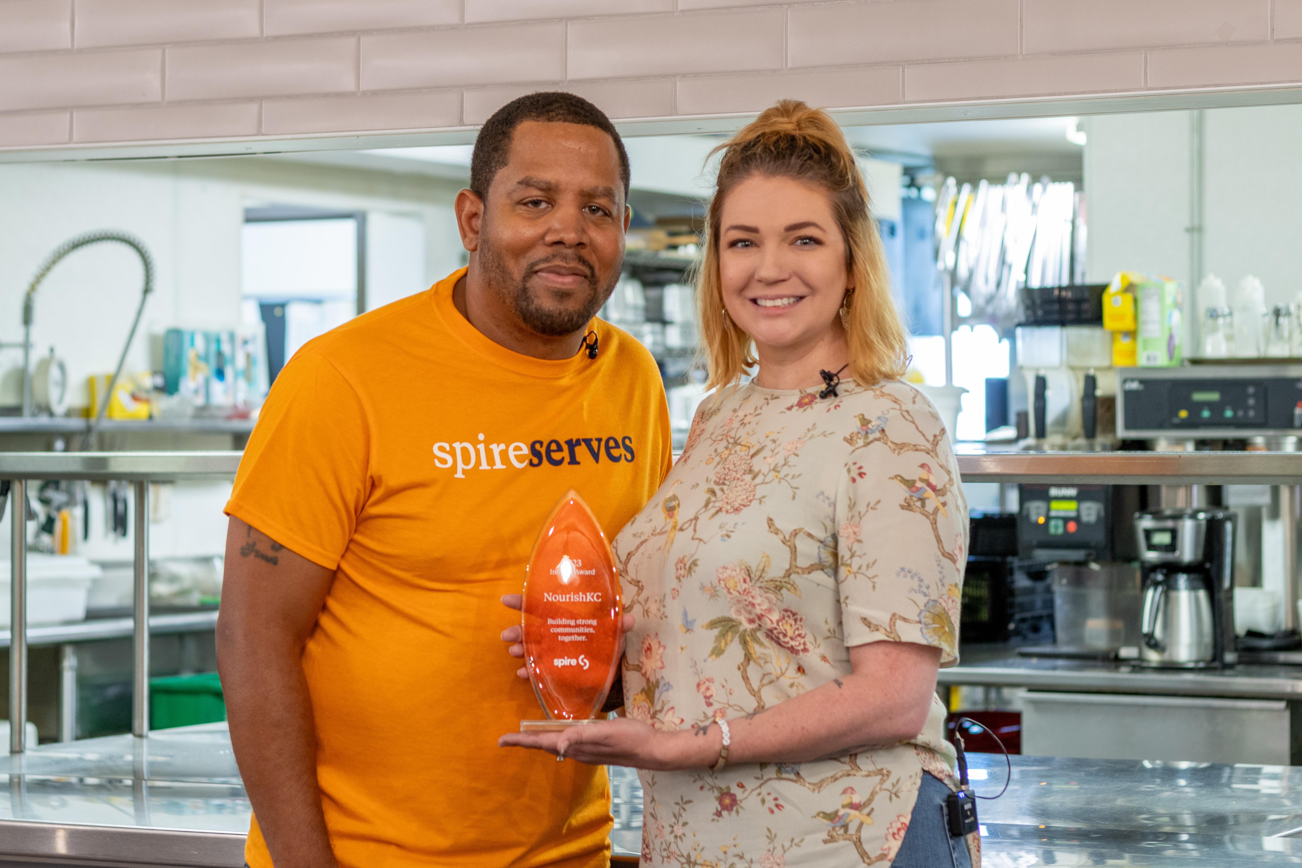 Image of Spire employee delivering trophy