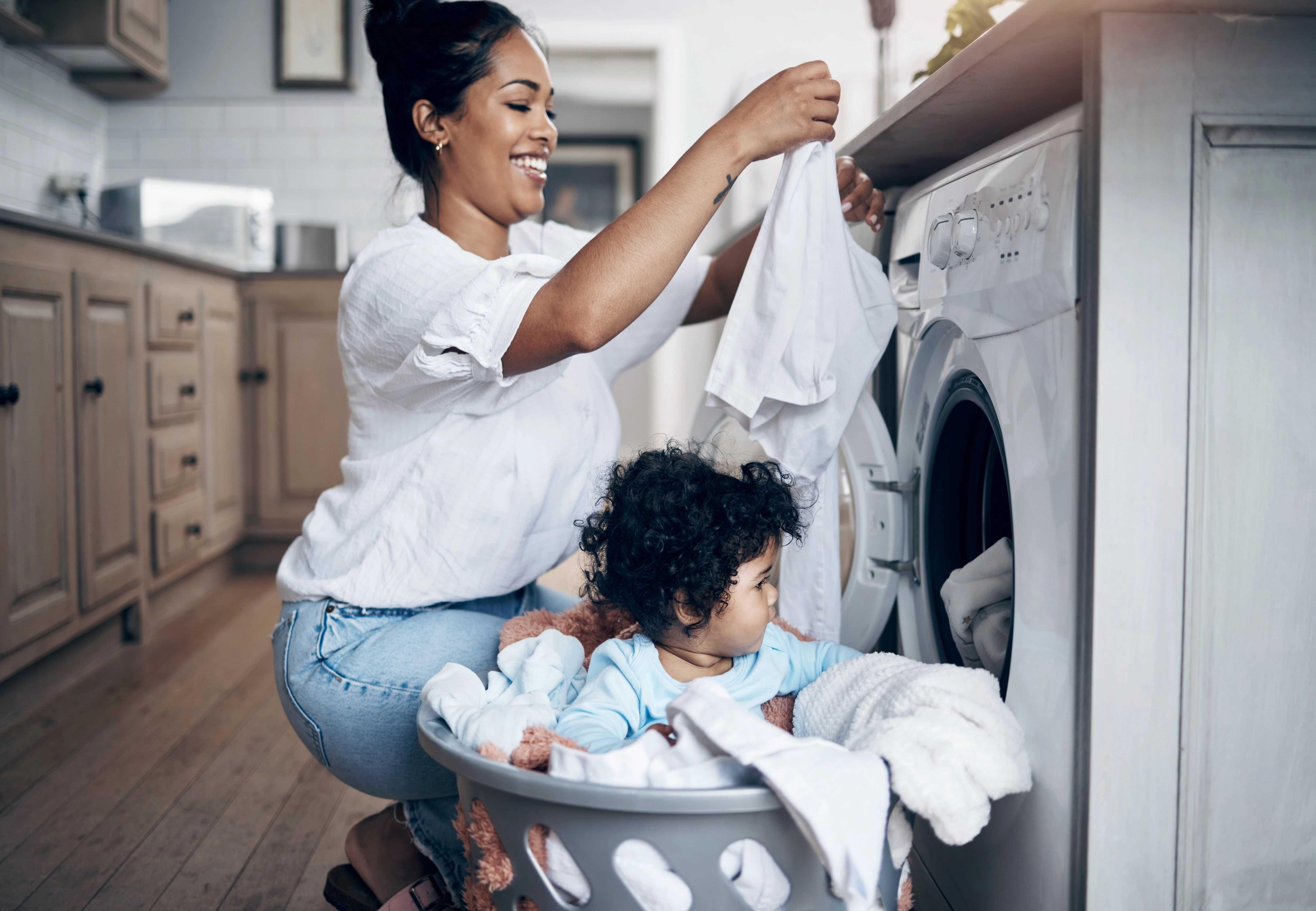 Image of woman folding laundry with her daughter