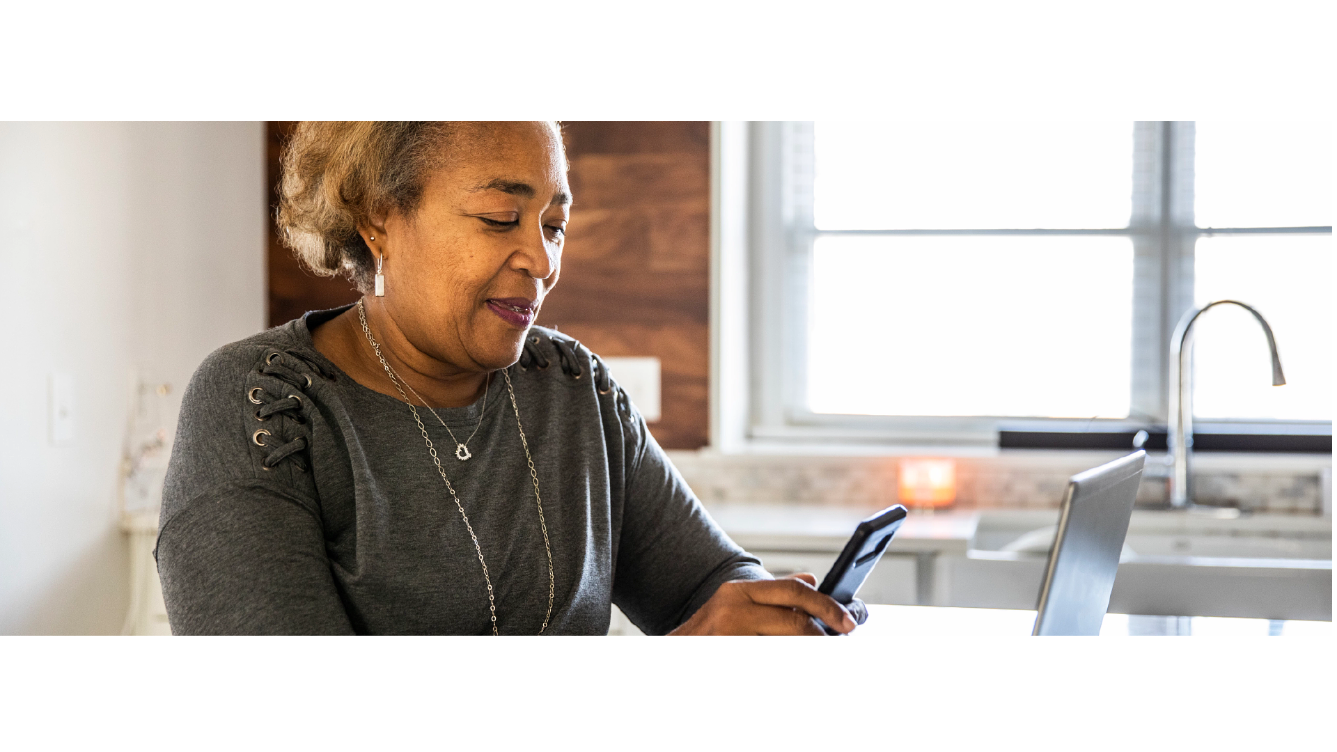 image of woman looking at her phone
