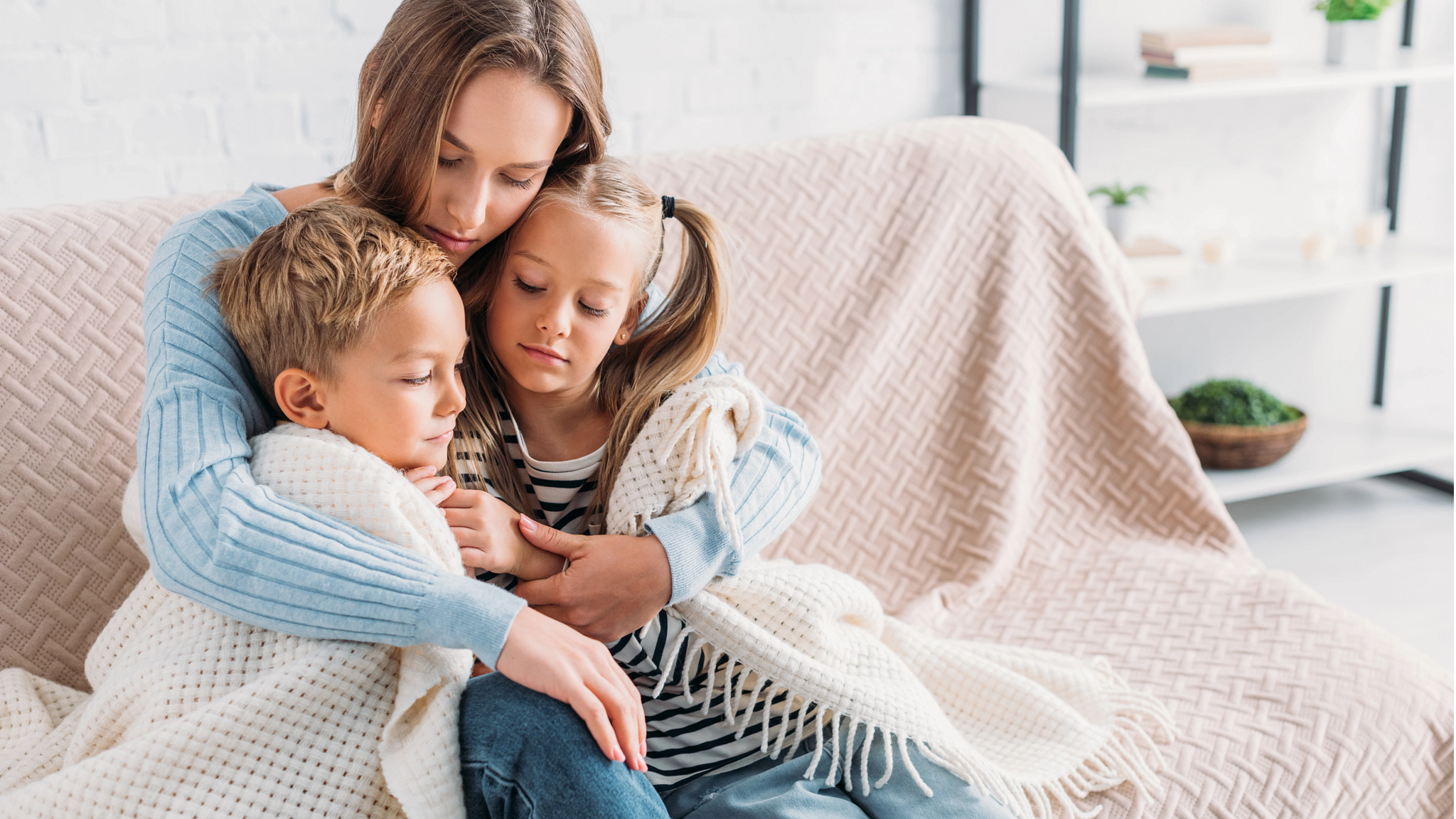 Image of family snuggling up on a couch
