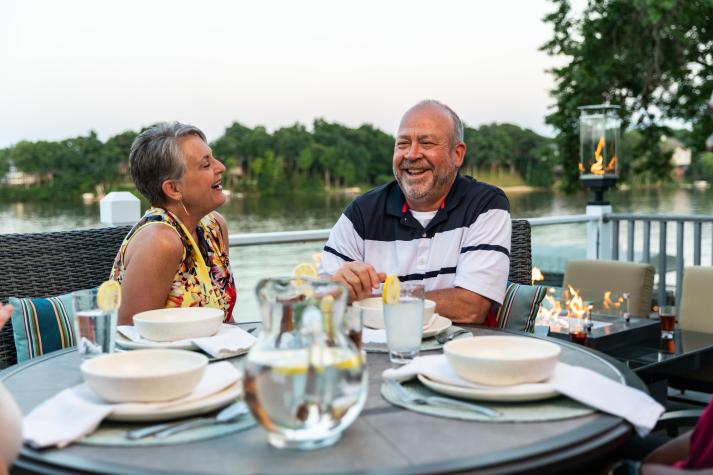 a couple laughing on their outdoor patio